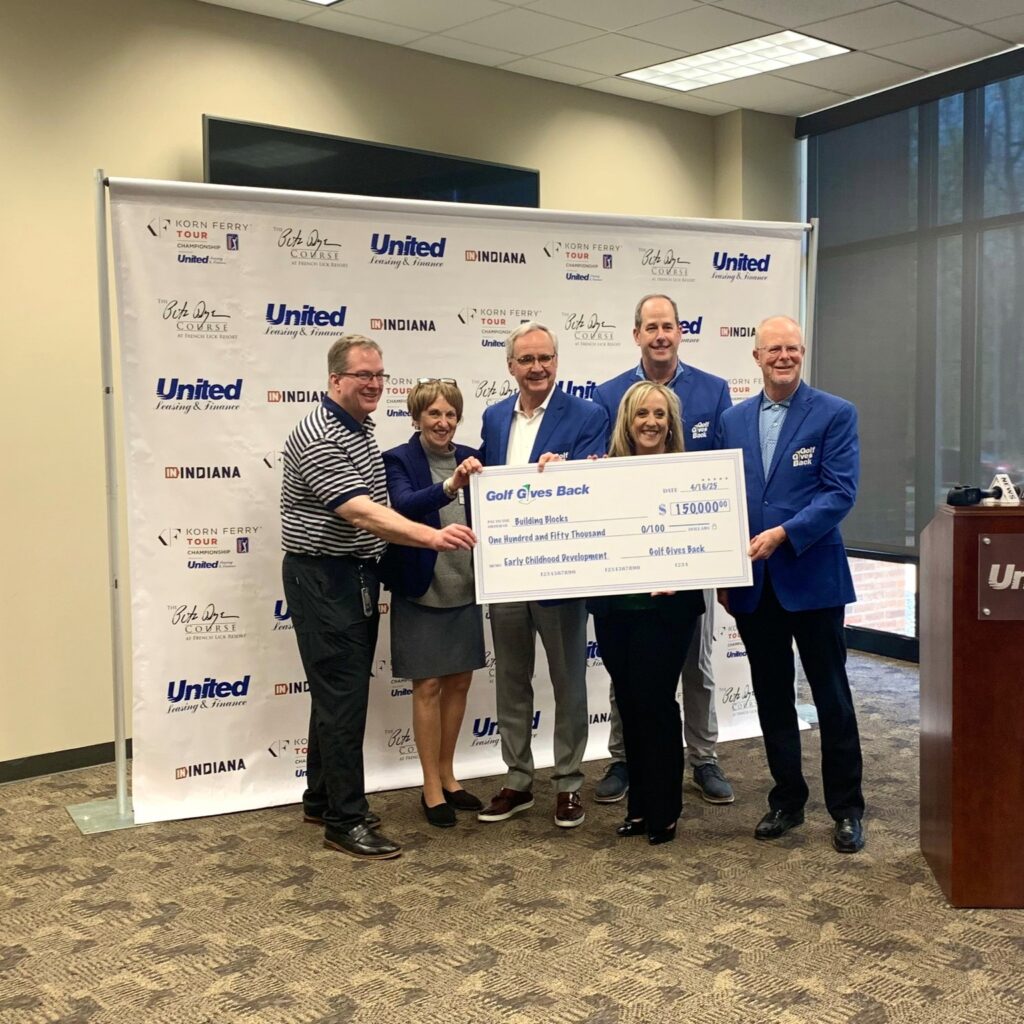 United team presenting a charitable donation check